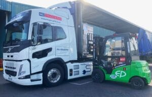 Electric truck with electric forklift in the foreground